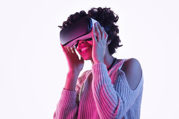 Smiling black teen girl in VR goggles