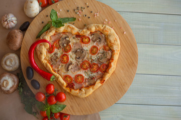 Pizza heart shaped on wood