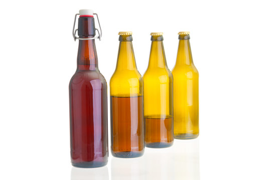 Row of beer bottles on white background