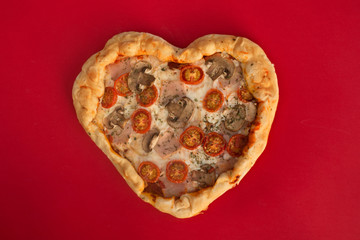 Pizza heart shaped on red