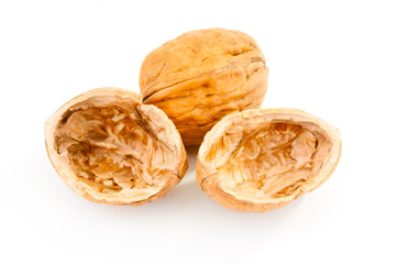 Walnut and empty walnut shell on white background