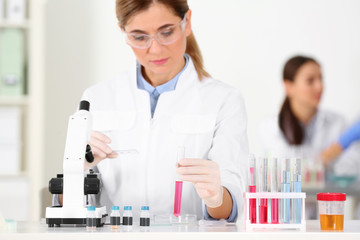 Female scientist working at table in laboratory. Research and analysis