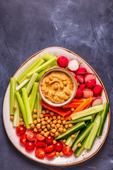 Hummus with various fresh raw vegetables.