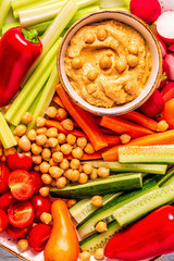 Hummus with various fresh raw vegetables.