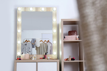 Dressing room interior with makeup mirror, table and shelving unit