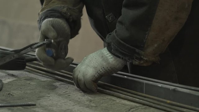 Blacksmith In Protective Gloves Measures The Required Length