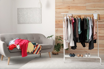 Mess in dressing room with sofa. Renew wardrobe