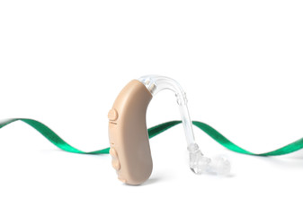 Hearing aid and ribbon on white background