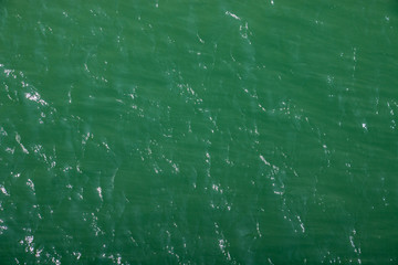 Green and shiny surface of calm Atlantic ocean