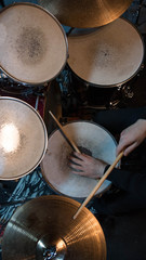 Professional drum set closeup. Drummer with drumsticks playing drums and cymbals, on the live music...