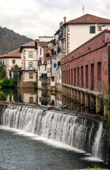 Village with river aside in the Basque Country on a cloudy day.