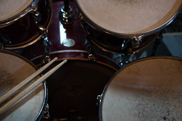 Fototapeta na wymiar Professional drum set closeup. Drummer with drumsticks playing drums and cymbals, on the live music rock concert or in recording studio 