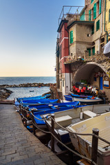 Fototapeta na wymiar View of narrow street with boats and sea in Riomaggiore, Cinque Terre. Italy