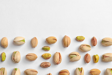 Composition with organic pistachio nuts on white background, top view. Space for text
