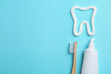 Tooth made of paste, tube, brush and space for text on color background, flat lay