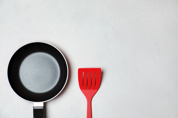 Flat lay composition with clean cookware, kitchen utensil and space for text on light background