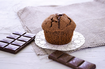 chocolate cupcake with cream, powdered sugar and berries