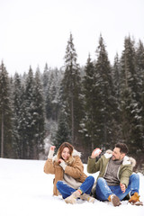 Fototapeta premium Couple spending time outdoors on snowy day, space for text. Winter vacation