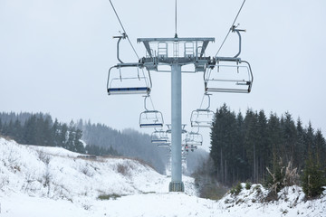 Chairlift with people at ski resort. Winter vacation