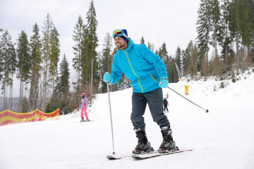 Fototapeta na wymiar Male skier on slope at resort. Winter vacation