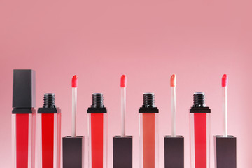 Liquid lipsticks with applicators on color background