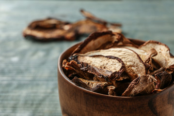 Bowl of dried mushrooms on table, closeup