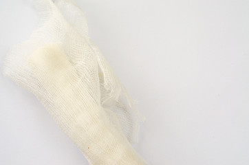 Medical glove and bandage on a white background.