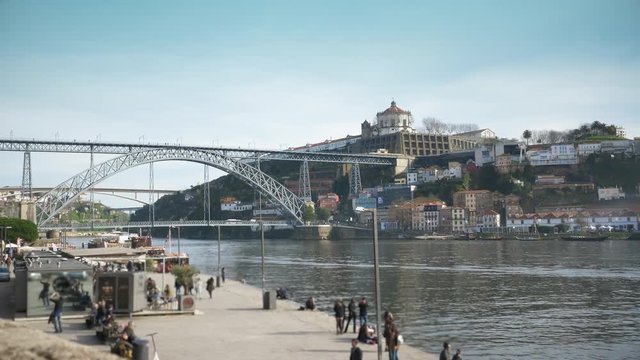 Porto City View People Walking Along Douro River. Porto is one of the oldest European centres, and its historical core was proclaimed a World Heritage Site by UNESCO in 1996