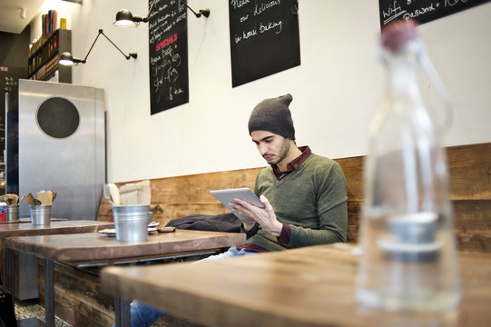 Caucasian man using a mobile device in a cafe