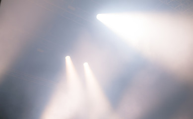 projectors light beam through smoke