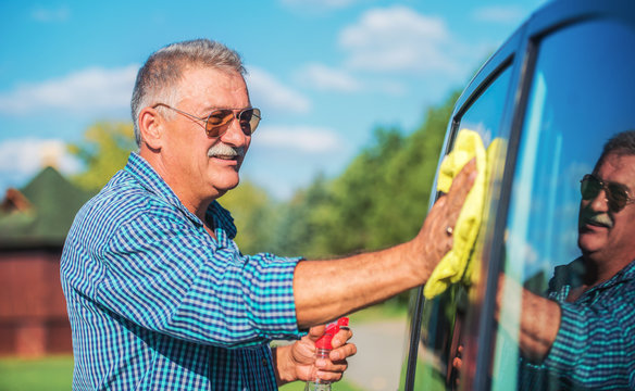 Senior Man Washing A Car