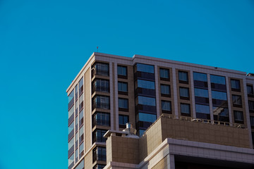 The delightful architecture of the city against the blue sky. Bright facades of buildings. New design solutions.     