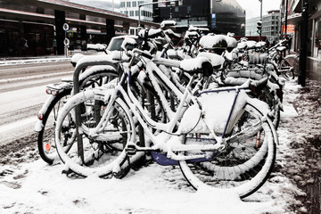 Bicycles covered in snow in the city street