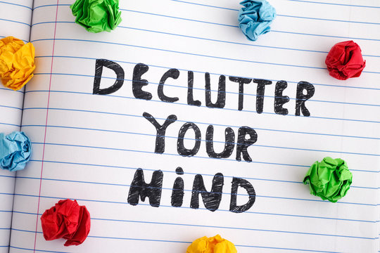  Phrase Declutter Your Mind On Notebook Sheet With Colorful Crumpled Paper Balls Around It