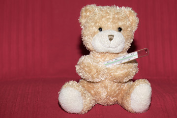 Teddy bear with a mercury thermometer