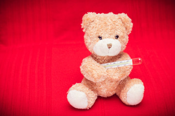Teddy bear with a mercury thermometer