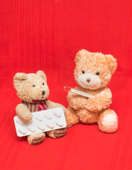 two toy bears mercury thermometer and pills