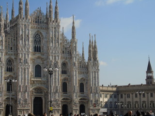 Naklejka premium Milan, Italy - 02/14/2018: Amazing photography to the Duomo of Milano in winter days with some people, a great blue sky and some details of the exterior part of the structure