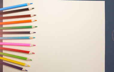 Color pencils lying on pastel beige background. Back to school concept. Colorful art studying and painting process. Drawing with pencils. Copy space place for postcard wish.
