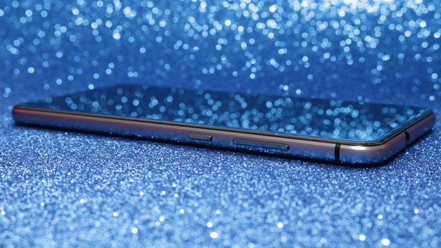 shiny smartphone  on blue Bokeh Effect Backgrounds