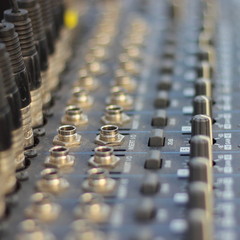 DJ mixer board - close up volume level graphic equaliser keyboard in perspective. Club electronic music, entertainment.