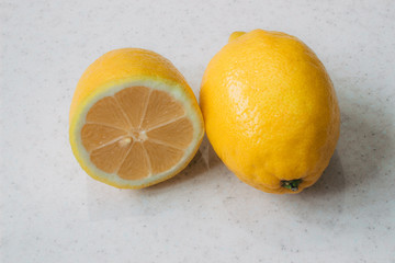 Yellow lemon on white surface