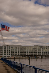Obraz premium The United States flag flying on the Hudson river in New Jersey