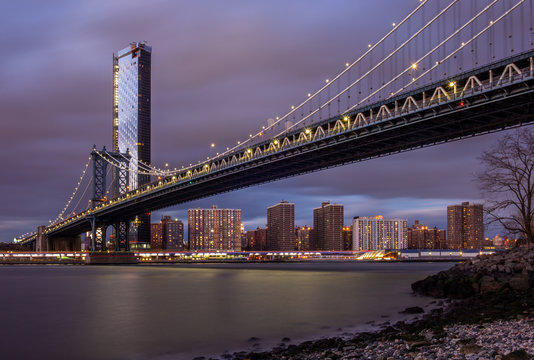 View of the Manhattan Bridge and Manhattan from the riverside of the East River at sunset - 2