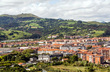 Fototapeta na wymiar Zarautz in the Basque Country, Spain, on a sunny day with the mountains in the background