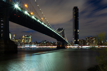View of the Manhattan Bridge and Manhattan from the riverside of the East River at night - 1