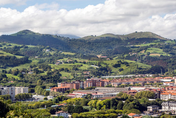 Naklejka premium Zarautz in the Basque Country, Spain, on a sunny day with the mountains in the background