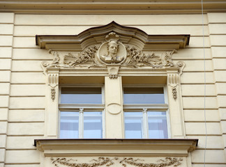 Close-up ornate windows of old building in Prague, Czech Republic.