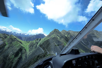 inside view of helicopter flying over new zealand mountains