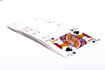 A set of playing cards on white background, jack on top